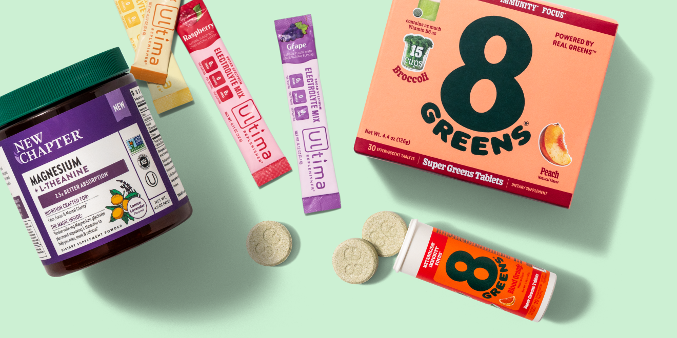 A jar of New Chapter Magnesium tablets, packets of Ultima and Nuun electrolytes, and 8Greens super greens tablets and tube, all arranged on a light green background.