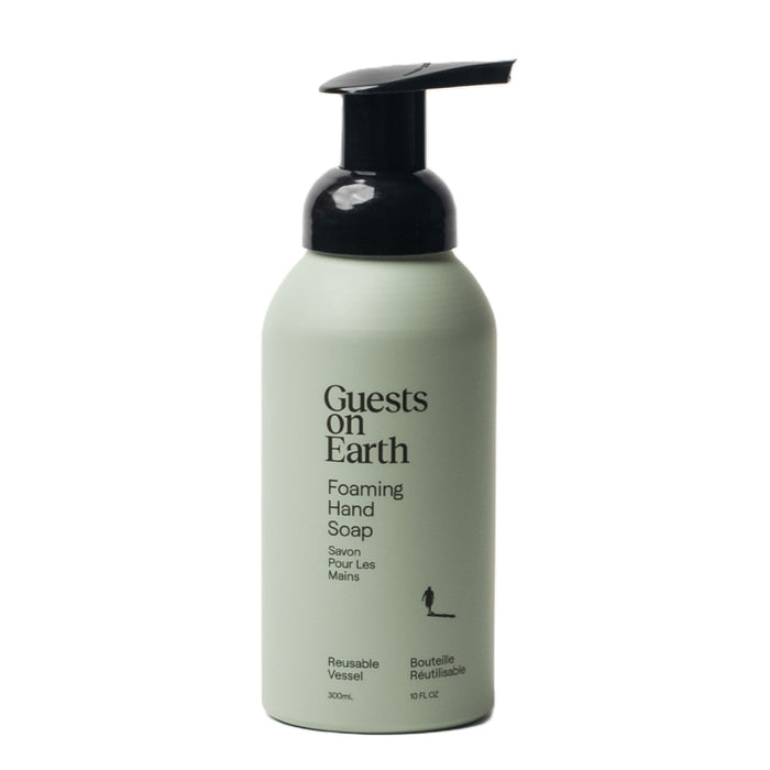 A Guests on Earth Citrus Oasis foaming hand soap features a green bottle with a black pump, and bears bilingual English and French text on its label about its reusability.