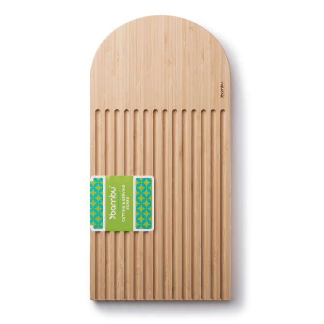 The Essential Bread Cutting Board by Bambu is a rectangular bamboo board with a rounded top and vertical grooves, shown from above with an eco-friendly green and blue label wrapped around its center. Perfect for serving cheese or bread.