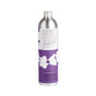 A tall, silver aluminum bottle from Dirty Labs stands against a white background, its purple and white label adorned with abstract shapes and text detailing product information and ingredients for the Bio Laundry Detergent with Phytolase® – Jasmine, Matcha, Vetiver.