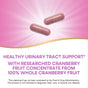 Two CranRx® Womens Care with Probiotics capsules by Natures Way on a pink background, showcasing urinary tract support and health from researched cranberry fruit concentrate. FDA evaluation disclaimer included.