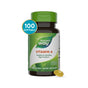 A bottle of Natures Way Vitamin A - For Healthy Eye Function with a green cap and label contains 100 softgels. One yellow softgel sits in front. The label highlights benefits for eye health and immune system support.