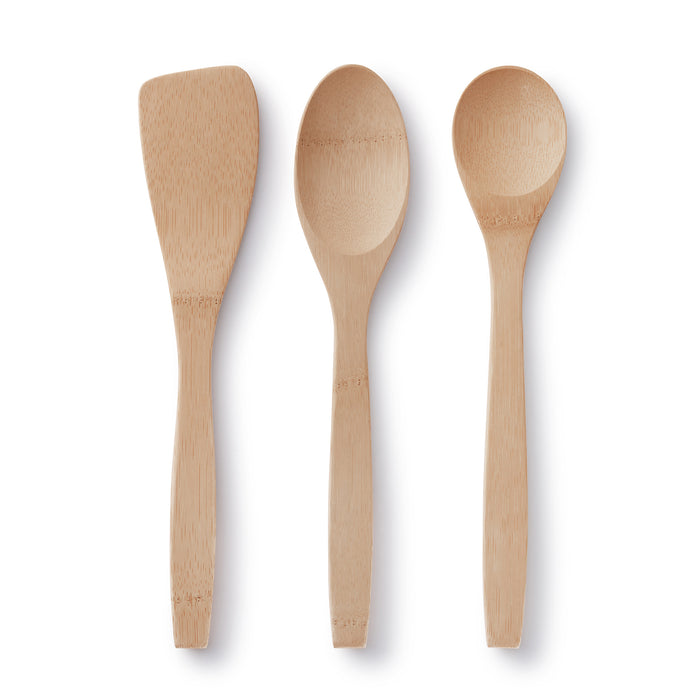 The Bambu Kitchen Basics Set of Bamboo Cooking Utensils features a flat spatula, large spoon, and small spoon made from light FSC-certified bamboo, arranged vertically on a white background.