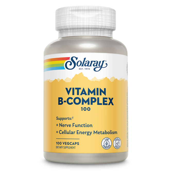 A bottle of Solaray Vitamin B Complex Veg Capsule features the Solaray logo, a yellow and white label with rainbow design, and text emphasizing energy support for nerves, cellular metabolism, and immune system function.