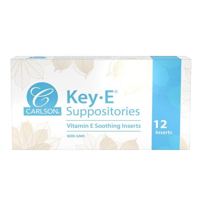 Carlson Labs Key E Suppositories come in a white and blue box with a leaf design, featuring the brand and product name, and stating 12 non-GMO vitamin E moisturizing inserts.