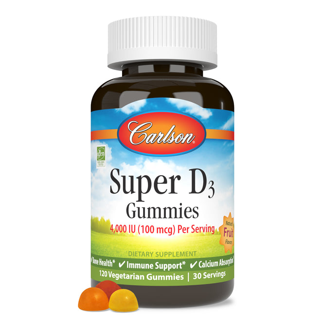 A bottle of Carlson Labs Super D Gummies is shown, containing 120 vegetarian vitamin D3 gummies. Two gummies—a yellow and an orange—sit in front. The label features fruit flavors and promotes immune support.