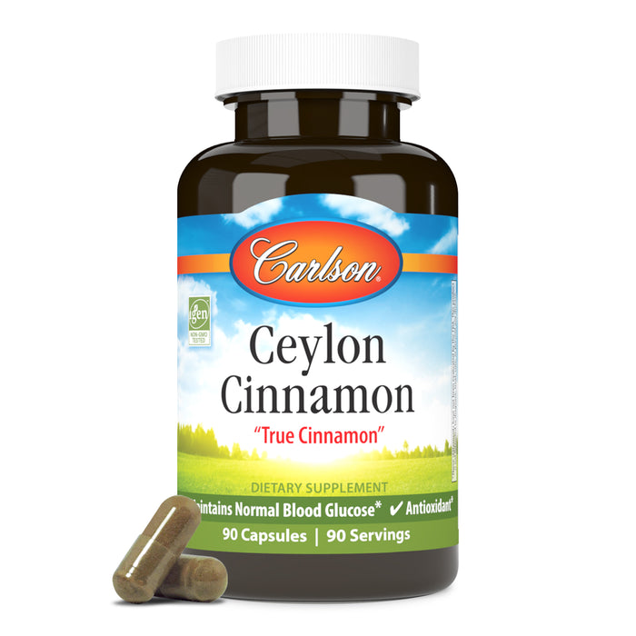 A bottle of Carlson Labs Ceylon Cinnamon dietary supplement contains 90 capsules. The label highlights "True Cinnamon," antioxidant support, and healthy blood glucose maintenance. Two capsules are placed in front of the bottle.