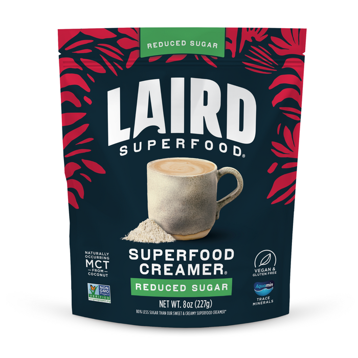 Front view of a Laird Superfood Reduced Sugar Superfood Creamer bag. The dark blue package with red leaf accents features vegan, reduced sugar, and gluten free labels.