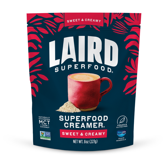 A package of Laird Superfood Sweet & Creamy Superfood Creamer shows a red mug of creamy coffee, vegan creamer powder, and red leaf accents.
