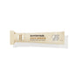 A beige tube of Sunniemade Hydrating Lip Balm – Coco Quench, infused with coconut and vanilla flavor, features minimalist line drawings of a bird and a coconut on the tube’s right side. Made with nourishing cocoa butter and packaged in recyclable materials, this lip balm offers both hydration and an eco-friendly choice.