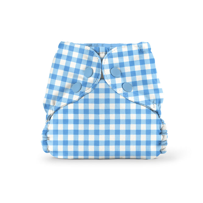 The Esembly Baby Outer Diaper Cover + Swim Diaper, Size 1, in light blue and white gingham, features two blue snaps and elastic leg openings. Made from 100% OEKO-TEX certified recycled fabric—an eco-friendly waterproof diaper cover.