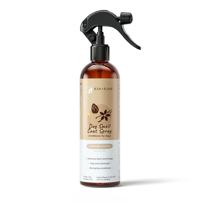 The kin+kind Dog Smell Coat Spray is a 12 fl oz brown spray bottle crafted in the USA using natural ingredients. Infused with essential oils, it features almond and vanilla scents, utilizing advanced plant technology for odor elimination and detangling.