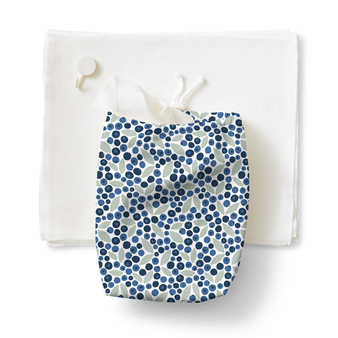 A set of Esembly Baby 100% Organic, Unbleached Reusable Paper Towels is laid flat, with the included polka dot toss bag placed on top. Set includes 12 towels, 1 roll, 1 toss bag, and 1 hook.