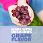 A child in a pink sweater holds red grapes. Text below reads: GENEXA Kids Pain and Fever Chewable, made with delicious grape flavor, provides gentle pain relief for children.