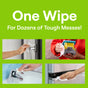 A promotional image with One Wipe For Dozens of Tough Messes! on a green background showcases Seventh Generation Multi-Surface Wipes, featuring four images demonstrating their use on a door handle, toy truck, faucet, and stainless steel.