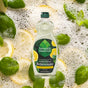 A bottle of Seventh Generation Dish Soap is displayed among lemon slices, green leaves, and bubbles. The label features lemon and leaf graphics, emphasizing its dye-free, USDA-certified biobased formula and fresh, natural appeal.