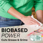 A person in a green sweatshirt wipes a white countertop with a cloth to remove sprinkles. Text reads, Drastically cuts grease & grime on household surfaces. A USDA Certified Biobased Product label shows 95% plant-derived cleaning agents in Seventh Generations All Purpose Cleaner.