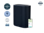 The Windmill Air Purifier Max by Windmill Air—a black, rectangular unit with vertical slats—is pictured beside a smartphone displaying an indoor air quality monitoring app. Surrounding the purifier are multiple certification and award badges, showcasing its advanced features like an activated carbon filter.