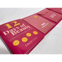 A close-up of the FaceTory 12 Days of Beauty Sheet Mask Set shows pink and red envelopes holding individual K-beauty sheet masks, neatly arranged on a white surface—ideal for all skin types.