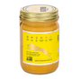 A glass jar of Big Spoon Roasters Banana Flax Wag Butter with a gold lid and yellow label featuring a running dog silhouette. This gluten-free, palm-free, soy-free, salt-free superfood provides nutritional benefits for dogs.