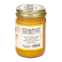 A glass jar of Big Spoon Roasters Crunchy Peanut Butter with a gold lid, made with runner peanuts, sorghum syrup, and sea salt. The side displays nutrition facts and a barcode.