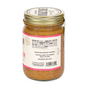 A glass jar with a gold lid holds Big Spoon Roasters’ Fiji Ginger Almond Butter, featuring heirloom mission almonds, sustainable ginger, and Jacobsen sea salt on the label. Some nutritional info is visible.