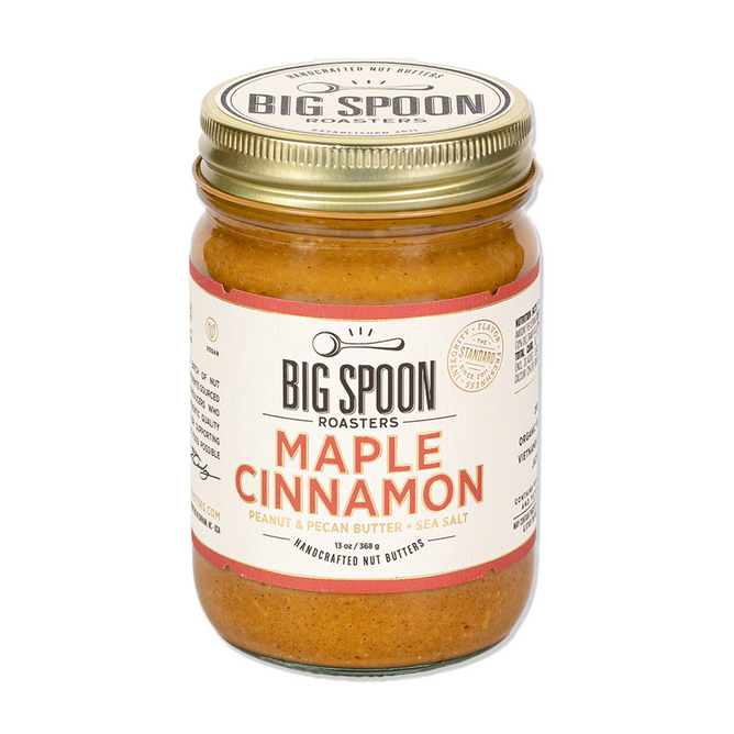 A small-batch Maple Cinnamon Peanut & Pecan Butter by Big Spoon Roasters, featuring sea salt, a gold lid, and a cream label with orange and black text.