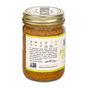 A glass jar of Big Spoon Roasters Pistachio Crunch Almond Butter features a gold lid and label with California pistachios, heirloom Mission almonds, handcrafted process, company branding, and sustainability icons.