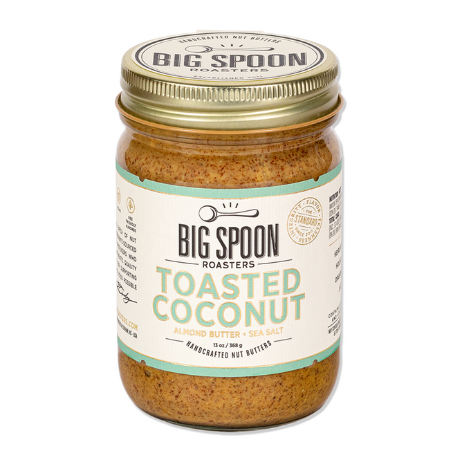 Big Spoon Roasters Toasted Coconut Almond Butter comes in a 13 oz (368g) jar with a gold lid and a white label with green and gold accents, made from heirloom Mission almonds and featuring low sugar.