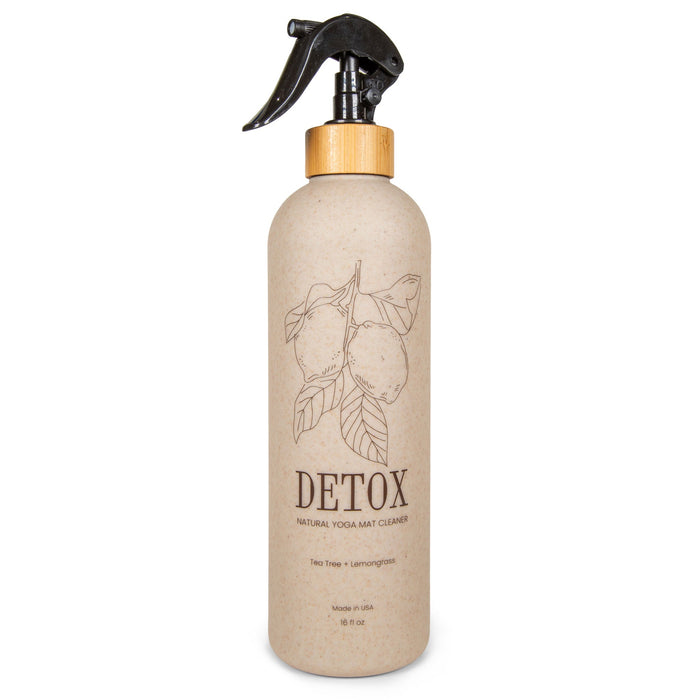 A beige spray bottle labeled “Yoga Mat Cleaner 16oz” by Yoloha Yoga features a lemon illustration, black trigger spray top, bamboo accent, and text highlighting tea tree and lemongrass scents. Made with organic essential oils, this mat spray is perfect for keeping cork yoga mats fresh and naturally clean.