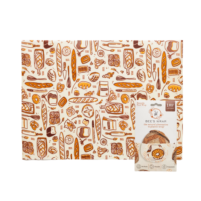 Bees Wrap Bread Wrap features bread and bakery-themed brown and orange illustrations. Shown with its packaging, this reusable wrap offers an eco-friendly way to store sourdough and baked goods while reducing single-use waste.