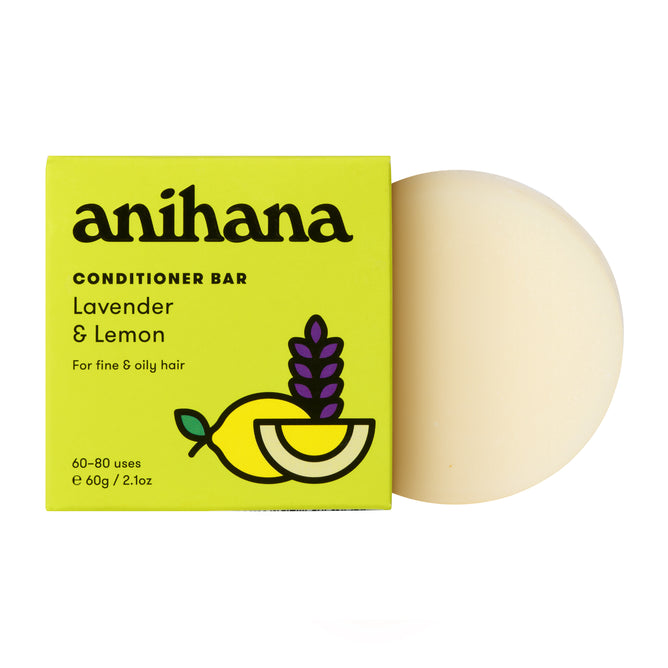 The Anihana Conditioner Bar (Fine & Oily Hair) is a round, off-white bar shown next to its yellow box featuring lemon and lavender sprigs—an eco-friendly hair care solution for fine and oily hair types.