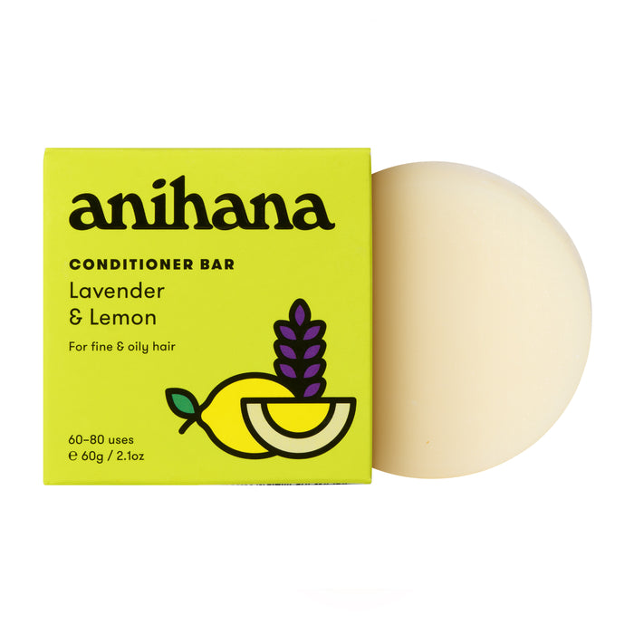 The Anihana Conditioner Bar (Fine & Oily Hair) is a round, off-white bar shown next to its yellow box featuring lemon and lavender sprigs—an eco-friendly hair care solution for fine and oily hair types.