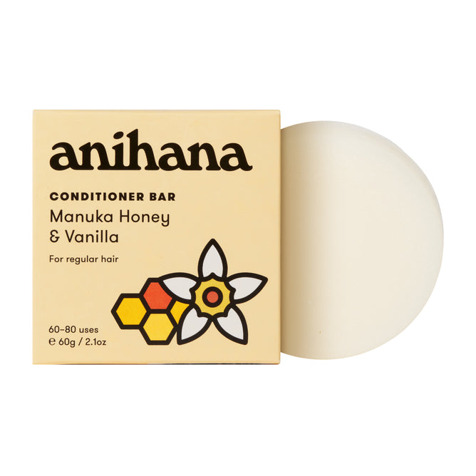 A round, white Anihana Conditioner Bar (Regular Hair) sits beside its beige box, featuring a flower and honeycomb design, offering sustainable hair care in a 60g size.