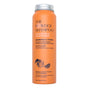 An orange cylindrical bottle labeled The Powder Shampoo Strengthening & Soothing Powder Shampoo for normal and sensitive scalps features fruit illustrations and text about its powder-to-foam formula that supports scalp balance.