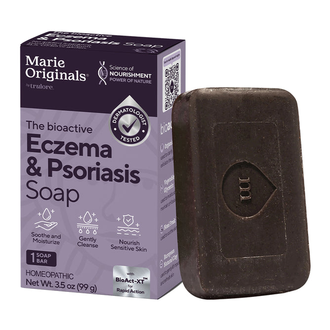 A box and bar of Marie Originals Eczema & Psoriasis Relief Soap. The purple box highlights dermatologist tested, soothes and moisturizes, and nourishes sensitive skin. The dark bar soap is embossed with “MO.”.