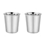 Two shiny, non-toxic Ahimsa Starter Sips Cups made of stainless steel sit side by side on a white surface. Their smooth finish and slightly flared rims make these identical cups ideal as toddler starter cups.