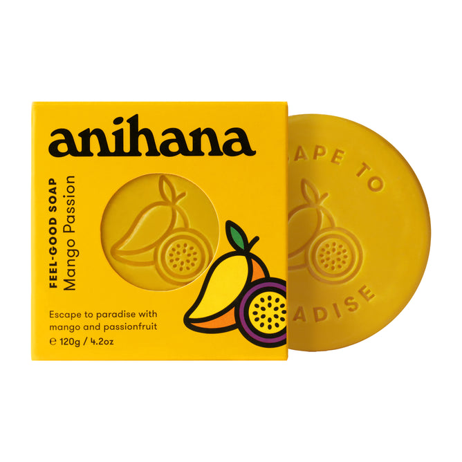 A yellow box of Anihana Feel-Good Soap, illustrated with mango and passionfruit, sits next to a round yellow sustainable soap featuring an embossed design.