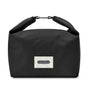The Black + Blum Lunch Bag features black fabric, a light label with “black+blum London” on the front, and a rolled top secured by a metal clasp—ideal for carrying your lunch or everyday snacks.