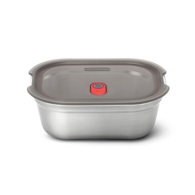 The Black + Blum Steel Food Box is a rectangular, microwaveable stainless steel lunch box with a gray plastic lid and a red vent button in the center, shown on a white background.