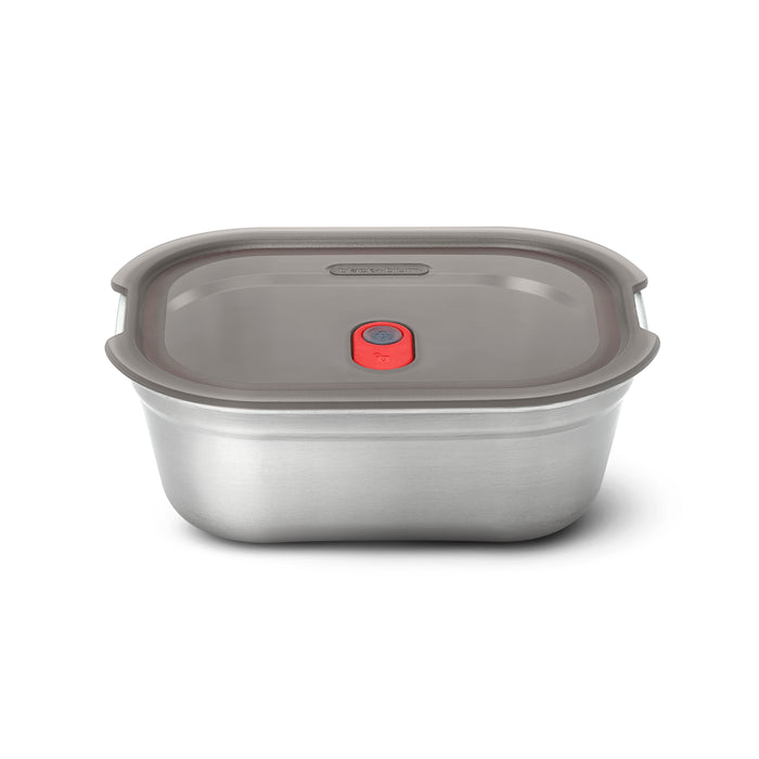 The Black + Blum Steel Food Box is a rectangular, microwaveable stainless steel lunch box with a gray plastic lid and a red vent button in the center, shown on a white background.