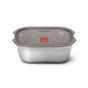 The Black + Blum Steel Food Box is a rectangular, microwaveable stainless steel lunch box with a gray plastic lid and a red vent button in the center, shown on a white background.