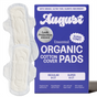 A purple box labeled August Night Pad is shown with two hypoallergenic pads next to it. The box highlights leak protection, comfort, and contains 8 regular and 8 super absorbent pads.