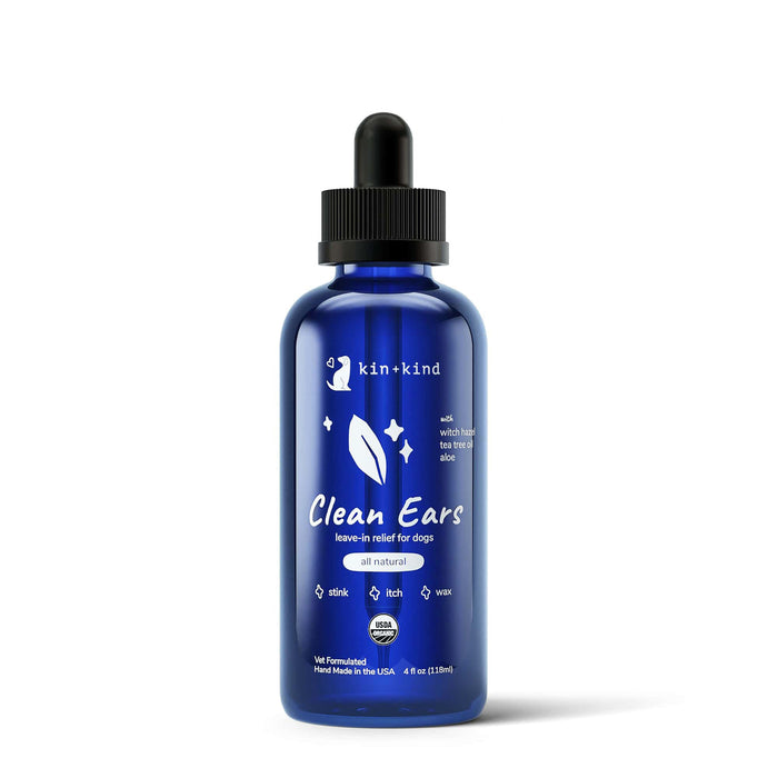 A blue bottle of kin+kind Clean Ears leave-in relief for dogs with a black dropper cap. The label highlights that it is all-natural and helps with stink, itch, and wax. The bottle contains 4 fl oz.