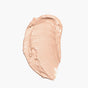 A swatch of Axiology Fungdation - Mushroom Foundation in beige is smoothly smeared on a white background.