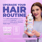 A smiling woman with brown hair holds a bottle of MaryRuth’s Hair Growth Max Liposomal. Purple text urges upgrading your hair routine for thicker, fuller hair and better growth, with certification logos on a pastel purple background.
