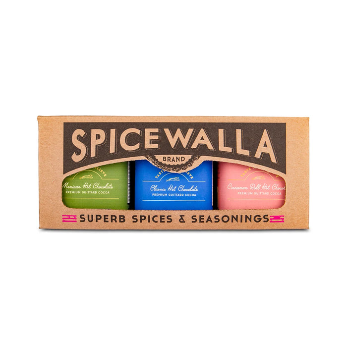The Spicewalla Hot Chocolate Drink Mix Collection features three tins—Mexican Hot Chocolate, Classic Hot Chocolate, and Cinnamon Roll Hot Chocolate—made with Guittard cocoa in colorful packaging.