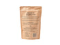 The image shows a beige packet of Grain & Gluten-Free Dog Biscuits by Portland Pet Food Company, featuring 100% whole food, human-grade ingredients with Pacific Northwest origins. The packaging emphasizes no preservatives or additives and includes feeding guidelines for your pet.