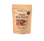 Portland Pet Food Companys Upcycled Dog Brew Biscuits come in a brown paper bag with a clear window, highlighting their all-natural and human-grade ingredients, sourced in the USA using spent grains.