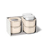 The Caraway Mini Food Storage Set W/ Storage includes cream and white non-toxic containers with lids, all organized in a light gray fabric box—perfect for effortless kitchen storage.